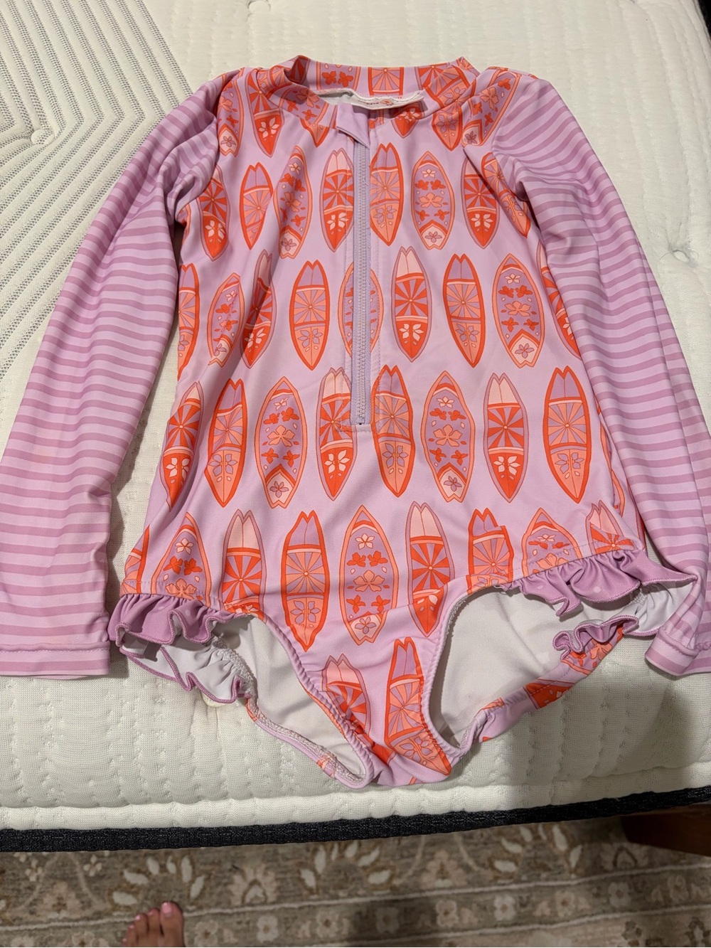 Long-Sleeve Kids One-Piece Swimsuit in Light Pink with Orange Surfboard Print